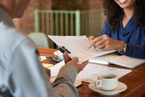 Lawyer reviewing paperwork with a client at a desk