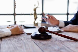 Gavel in the foreground during a legal consultation between two people